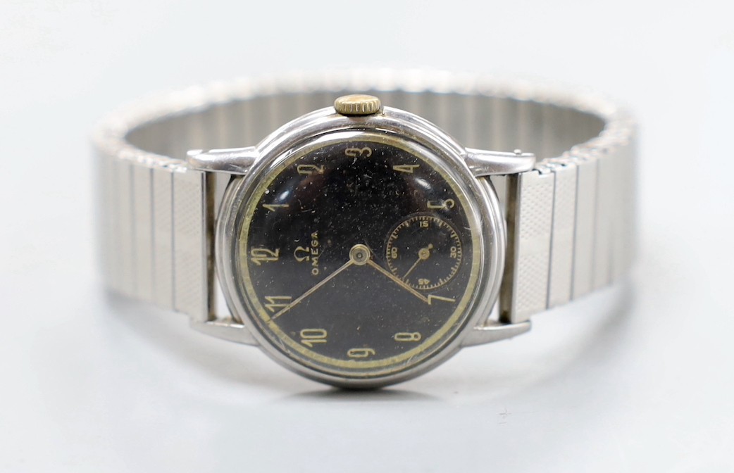 A gentleman's stainless steel Omega manual wind wrist watch, case diameter 29mm, with black Arabic dial and subsidiary seconds, on associated flexible strap.